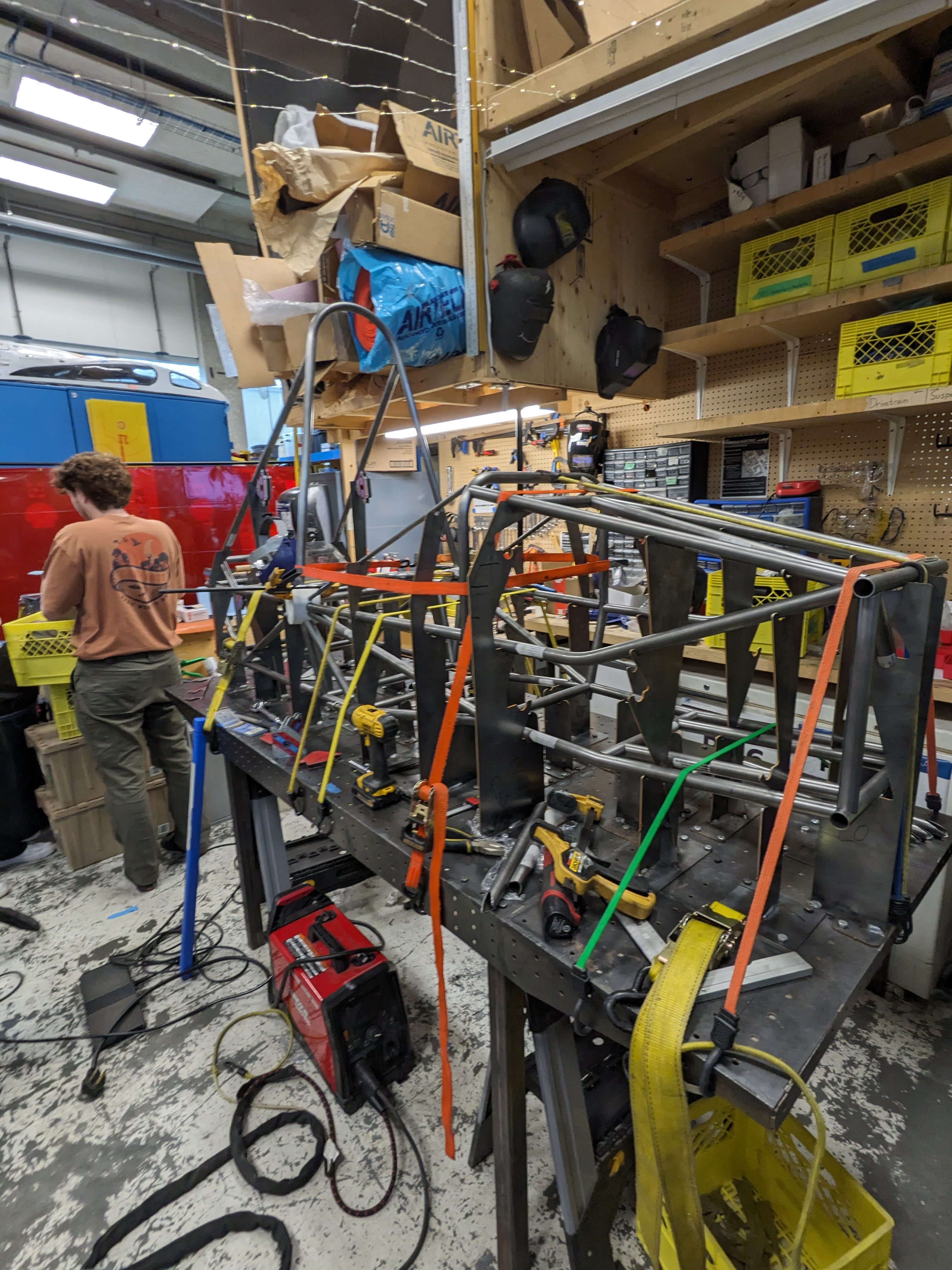 2026 chassis secured in the custom welding jig on the fixture table