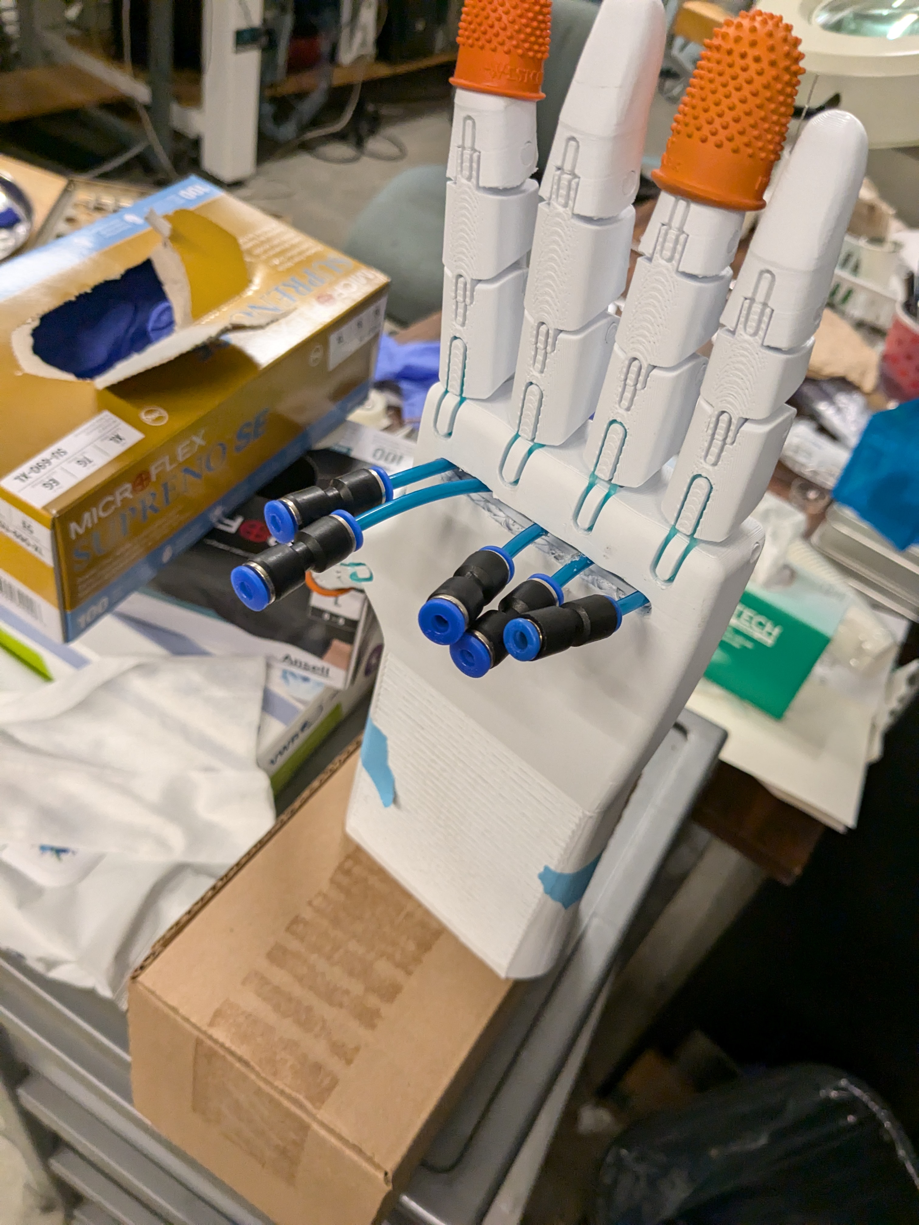 Back of the prosthetic hand showing pneumatic lines and quick-connect fittings